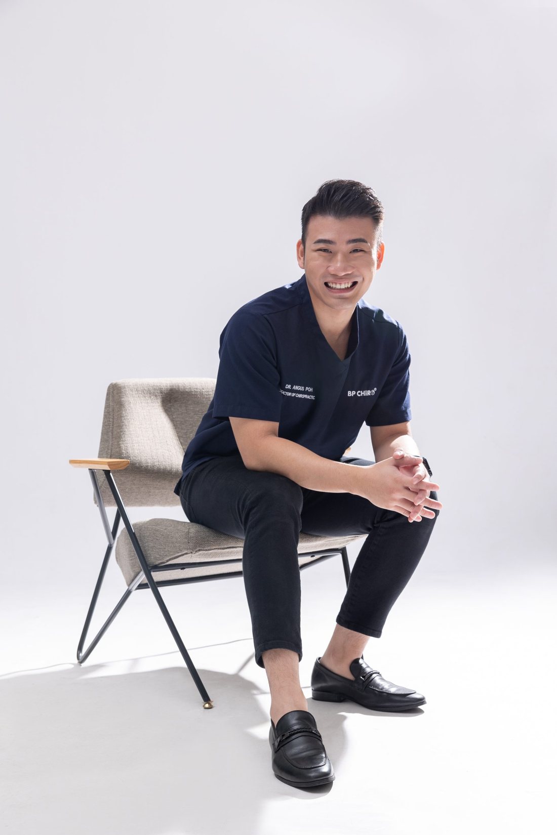 Dr. Angus Poh, founder of BP Chiro, seated and smiling