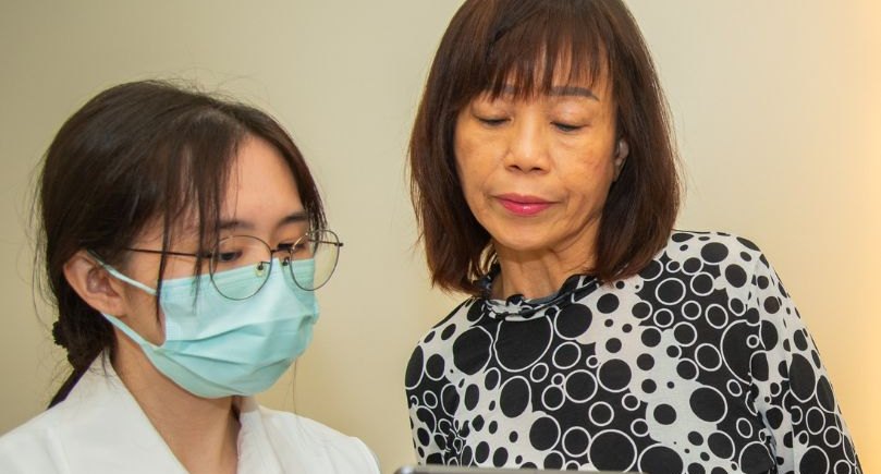 Clinician going through a patient's history on a tablet